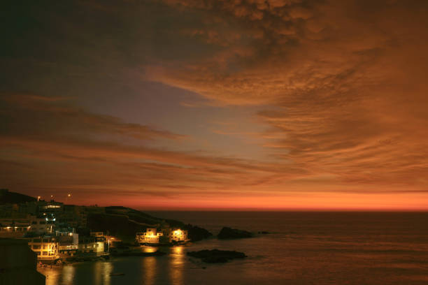 breathtaking view of orange sunset in san bartolo beach,lima,peru