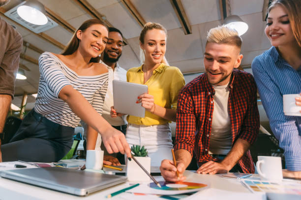 istock Young designers discussing ideas for sketches and choosing colors 2196416357