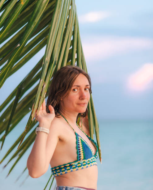 istock Woman on a beach at sunset 2196418171