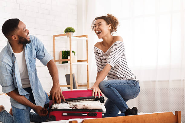 Couple Packing a Suitcase Together for a Vacation While Enjoying Each Other's Company