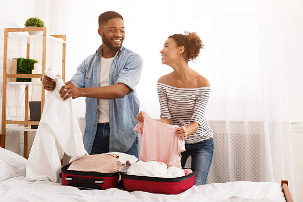 istock Packing for a Trip Together in a Cozy Bedroom With a Cheerful Atmosphere 2196419691