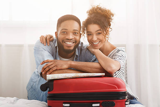 istock Happy couple leaning on suitcase, preparing for vacation 2196419734