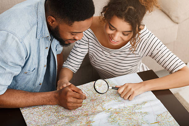 istock African-american couple searching best route on map 2196419747