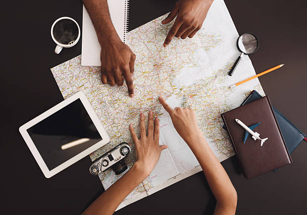 istock Young couple planning honeymoon vacation trip with map 2196419758