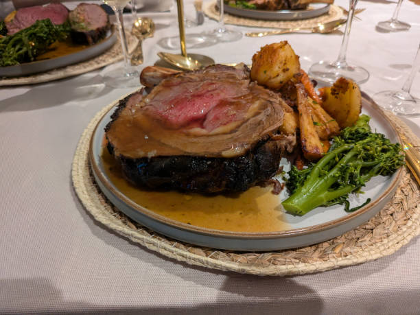 istock Roasted prime rib served on an elegant table with greenery and wine glasses at a festive gathering 2196419813