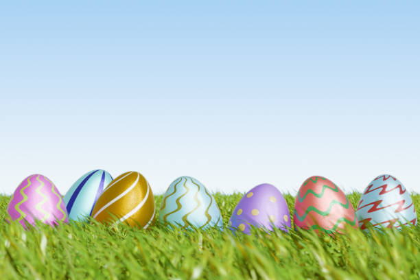 istock Colorful Easter eggs resting on green grass under a clear sky, celebrating the Easter holiday. 3d rendering 2196422124