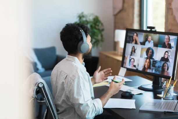 istock Man in Headphones Participating in a Virtual Group Meeting 2196422493