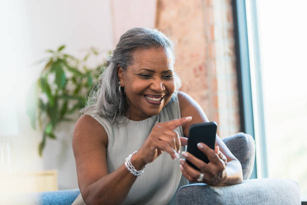 istock Smiling Senior Woman Using Smart Phone, Casual Home Setting 2196422536