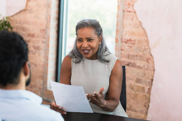 istock Mature Woman Reviewing Documents with a Colleague 2196422549