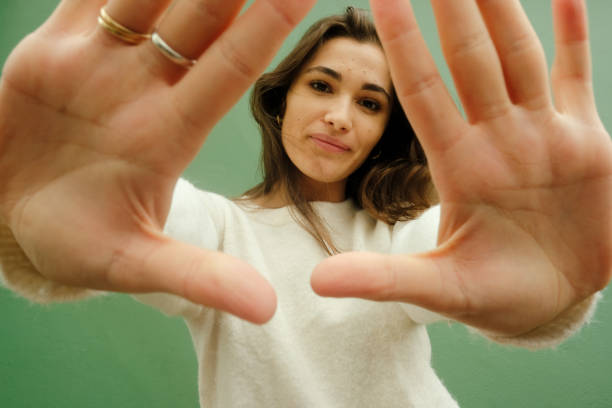 istock Woman against green wall 2196424859