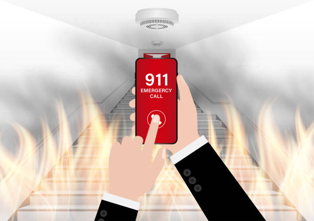 istock 911 Emergency Call for Fire Truck about Burning House and Burning Building. Hand Holding Smartphone with 911 Emergency Call. 2196426856