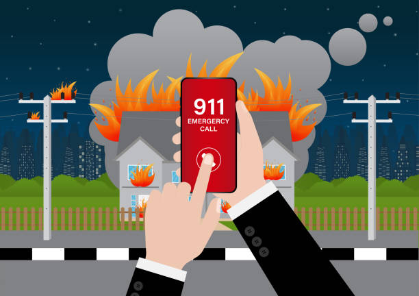 istock 911 Emergency Call for Fire Truck about Burning House and Burning Building. Hand Holding Smartphone with 911 Emergency Call. 2196427627