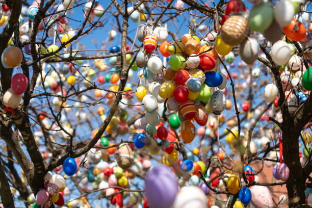 istock A vibrant Easter tree adorned with numerous colorful eggs hanging from its branches. 2196431511