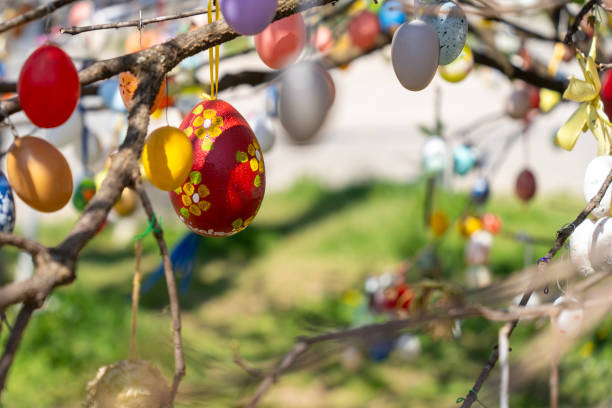 istock A vibrant Easter tree adorned with numerous colorful eggs hanging from its branches. 2196431513