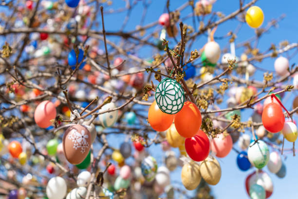 A vibrant Easter tree adorned with numerous colorful eggs hanging from its branches.