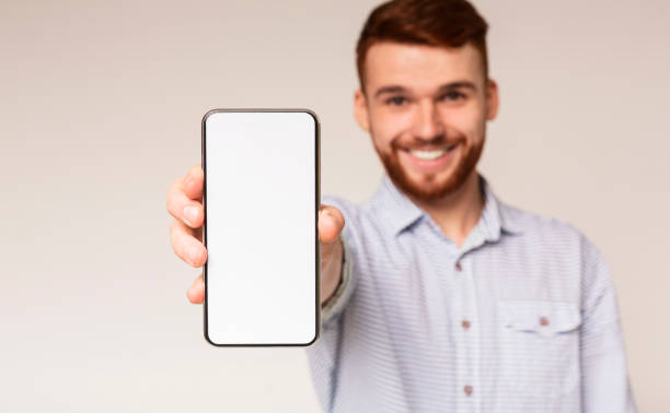 istock Young guy showing his phone with blank space on camera 2196431568