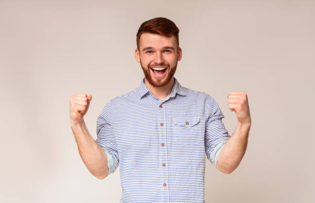 istock Cheerful guy showing his biceps and smiling 2196431603