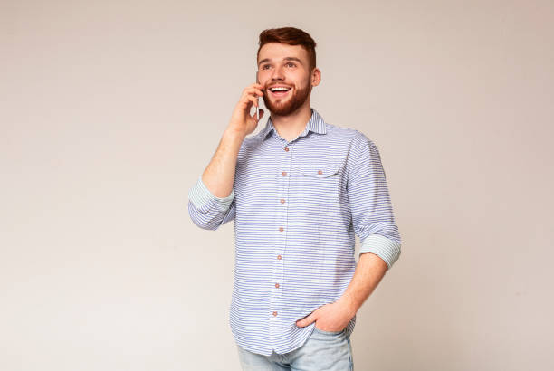 istock Cheerful man using his phone and widely smiling 2196431612