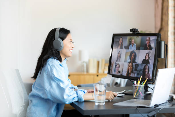 istock Woman on Video Conference Call with Colleagues, Smiling 2196433241
