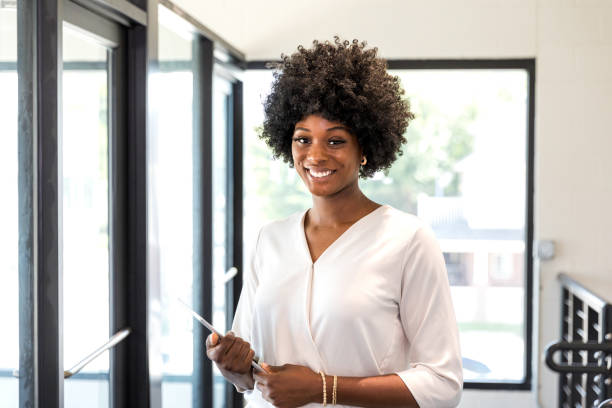 istock Confident Businesswoman Smiling, Holding Tablet, Modern Office 2196433293