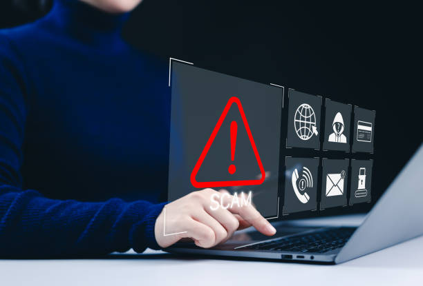 istock Scam alert warning, Cybersecurity concept. A woman using laptop, warning sign for scams with icons online threats, phishing, and cybersecurity. Unknown person, suspicious scammer, fraud detection, 2196434705