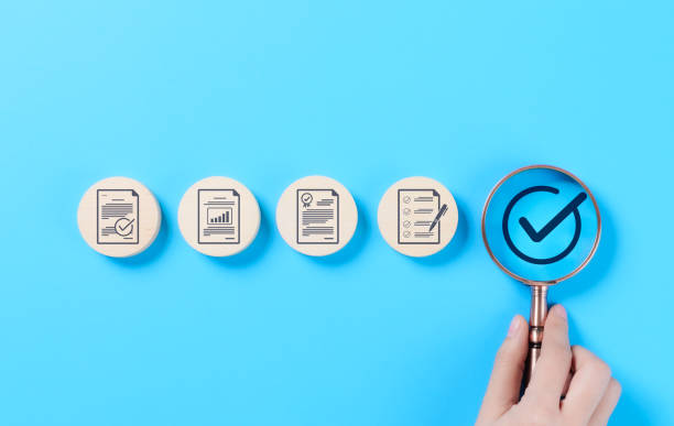 istock Quality control and certification assurance concept. A magnifying glass highlighting a checkmark certification and quality assurance icons, standard compliance, approval, and business quality control. 2196434728
