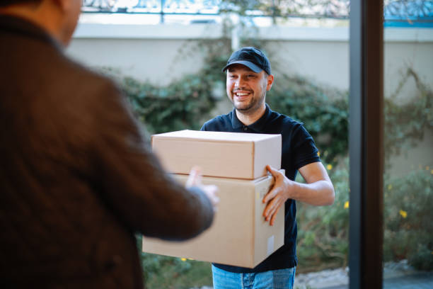 istock Close up of hands cargo staff are delivering cardboard boxes with parcels inside to the recipient's hand. 2196437705