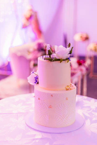 istock Beautiful creamy white wedding cake decorated with flowers 2196438858