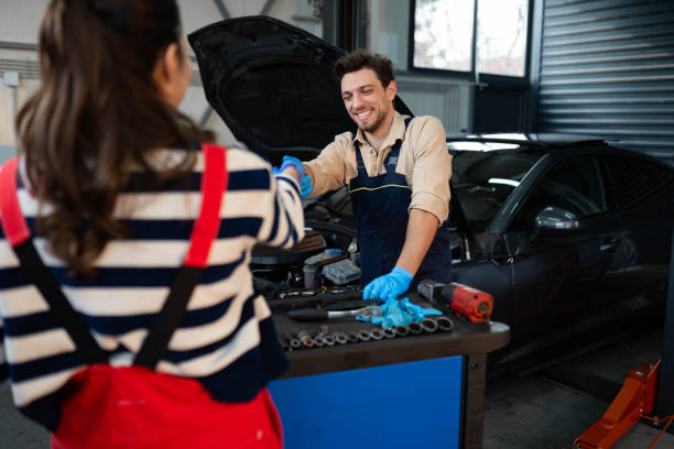 istock Two Handsome mechanic worker in uniform working on car 2196438913