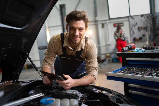 istock Joyful automotive technician standing at the service station 2196439029