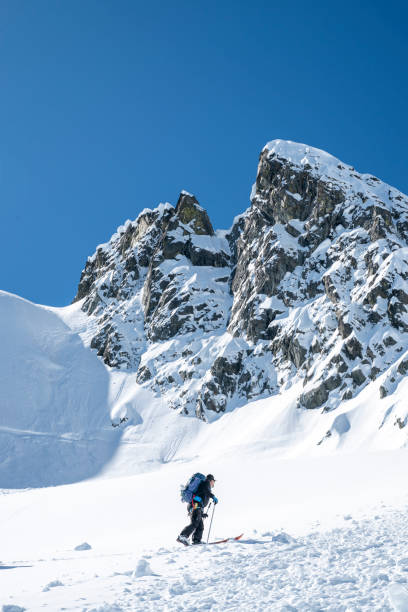 istock Backcountry skier climbs mountain 2196439495