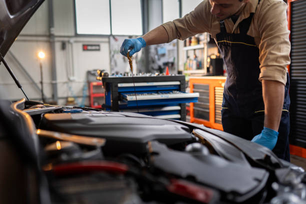 istock Mechanic checks the oil level 2196439497