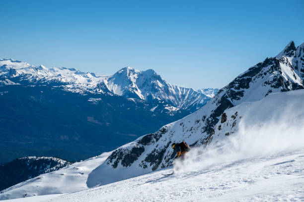 istock Backcountry skier descends mountain top 2196439621