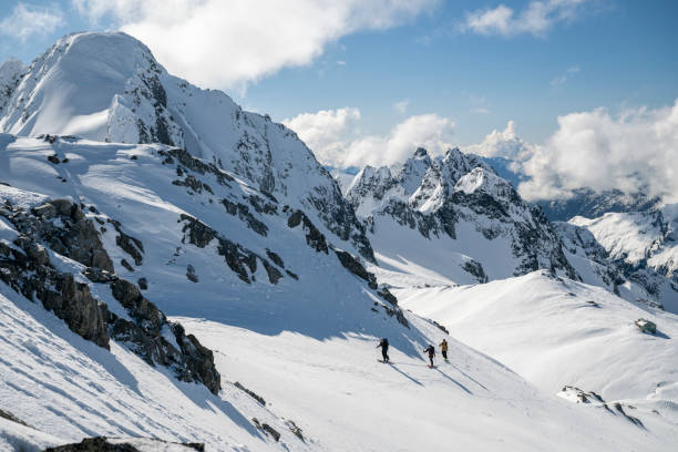 istock Group of backcountry skiers climb mountain 2196439659
