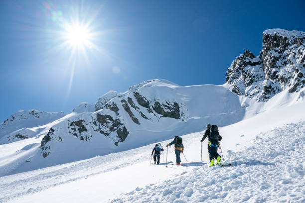 istock Group of backcountry skiers climb mountain 2196439701