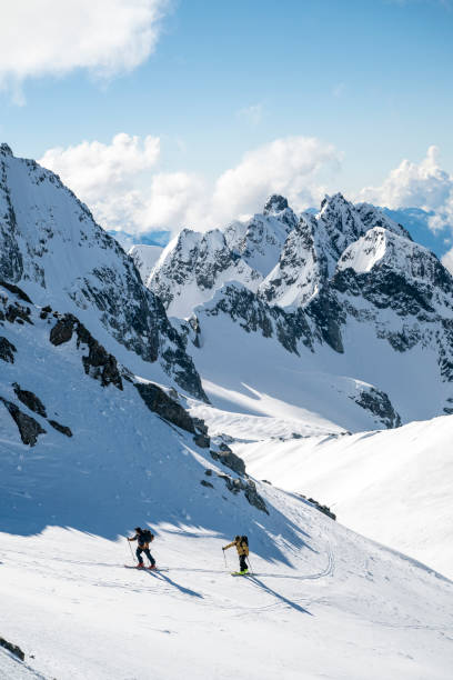 istock Backcountry skiers climb mountain 2196439793