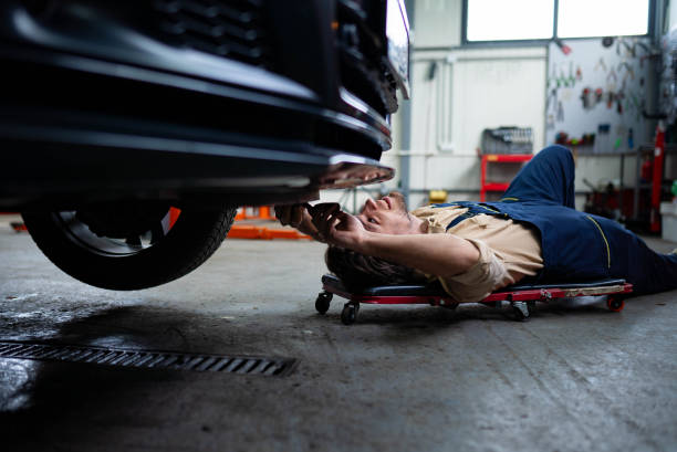 istock Mechanic under car in auto repair shop 2196439861