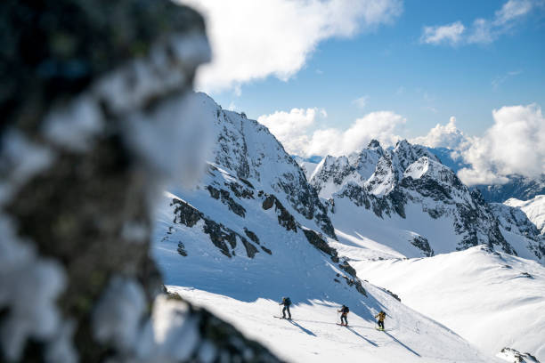 istock Group of backcountry skiers climb mountain 2196439889