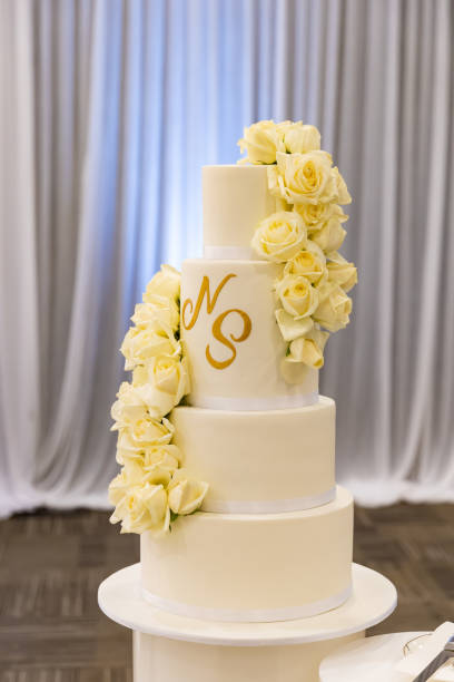 istock Beautiful creamy white wedding cake decorated with flowers 2196440216