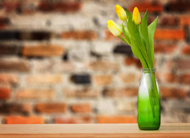 yellow tulip on a wooden table