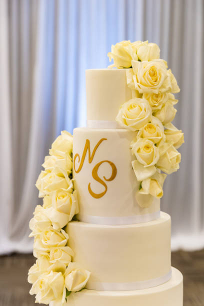 istock Beautiful creamy white wedding cake decorated with flowers 2196440466