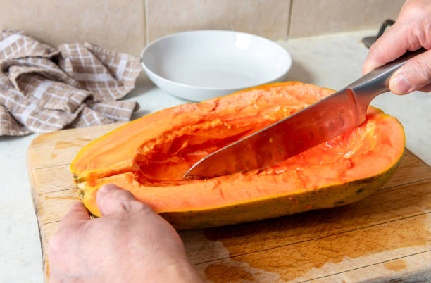 istock Cutting half of a papaya in two. 2196441442