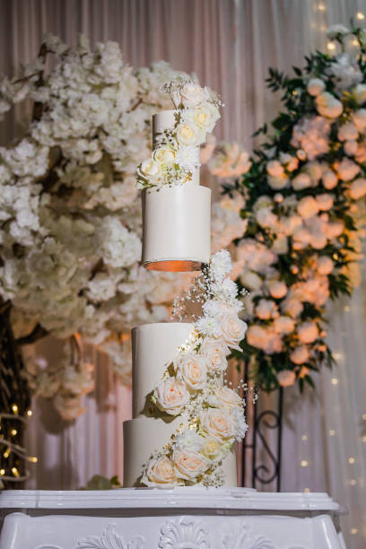 istock Beautiful creamy white wedding cake decorated with flowers 2196441902