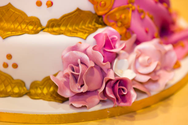 istock Beautiful creamy white wedding cake decorated with flowers 2196442403