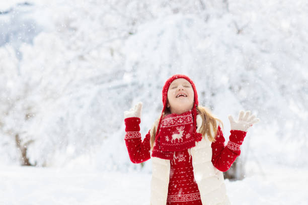 istock Child playing in snow on Christmas. Kids in winter 2196445844