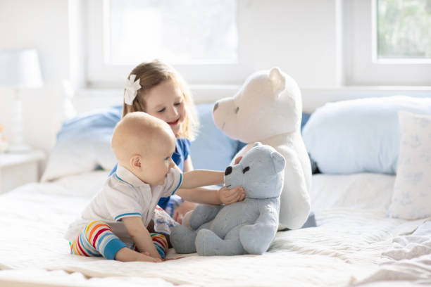 adorable multicultural kids holding teddy bears,  isolated on white