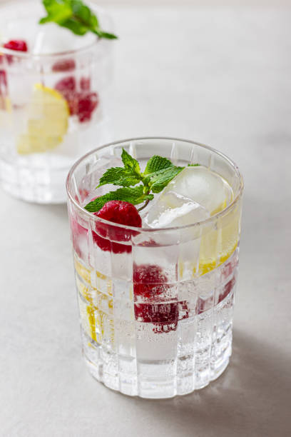 istock Raspberry cocktail with ice in a glass on a light background 2196447219