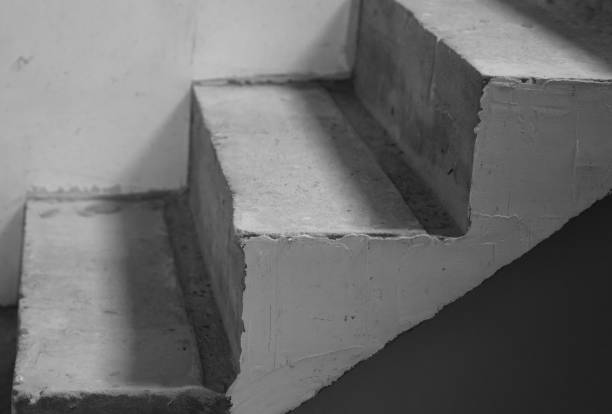 istock Textured concrete stairs in a dimly lit interior space during daytime 2196447430