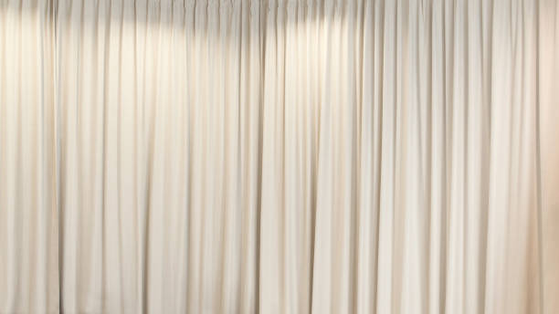 istock white curtain curtain that dropped down as a straight line. Background for inserting text, empty spaces 2196447721