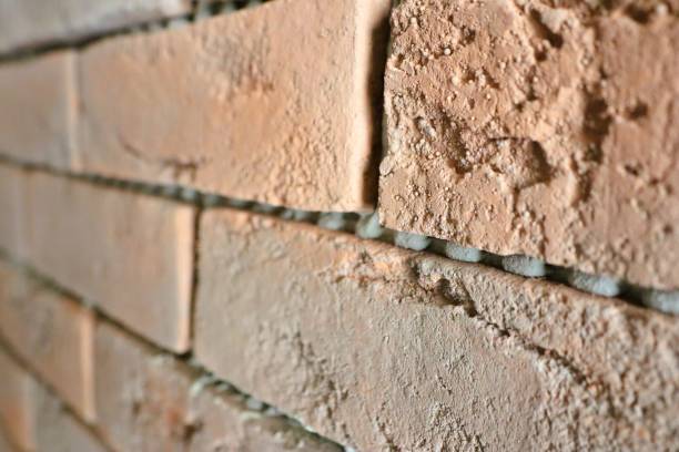 istock CloseUp View of a Textured Brick Wall Featuring Distinctive Mortar Joints and Patterns 2196449168
